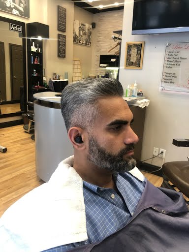 Barber at work inside Deja Vu Barbershop