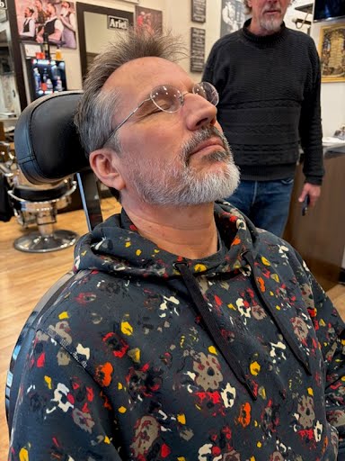 Hot towel shave in progress at Deja Vu Barbershop